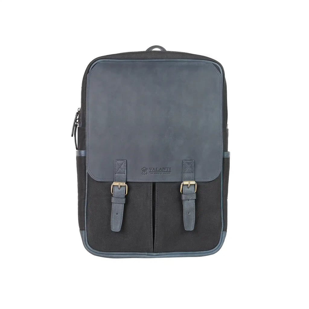 Front view of a dark canvas laptop backpack with a faux leather flap, twin buckled straps and front pockets from valanti.co.uk Backpack collection